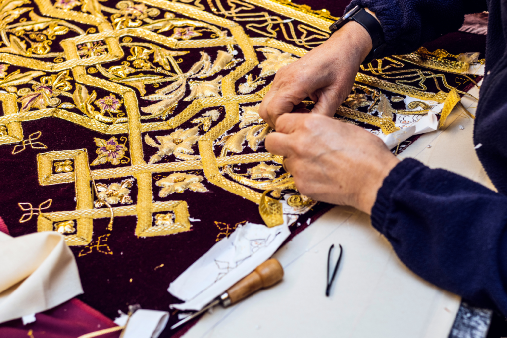 A professional works on crafting a beautiful embroidery typical of Holy Week