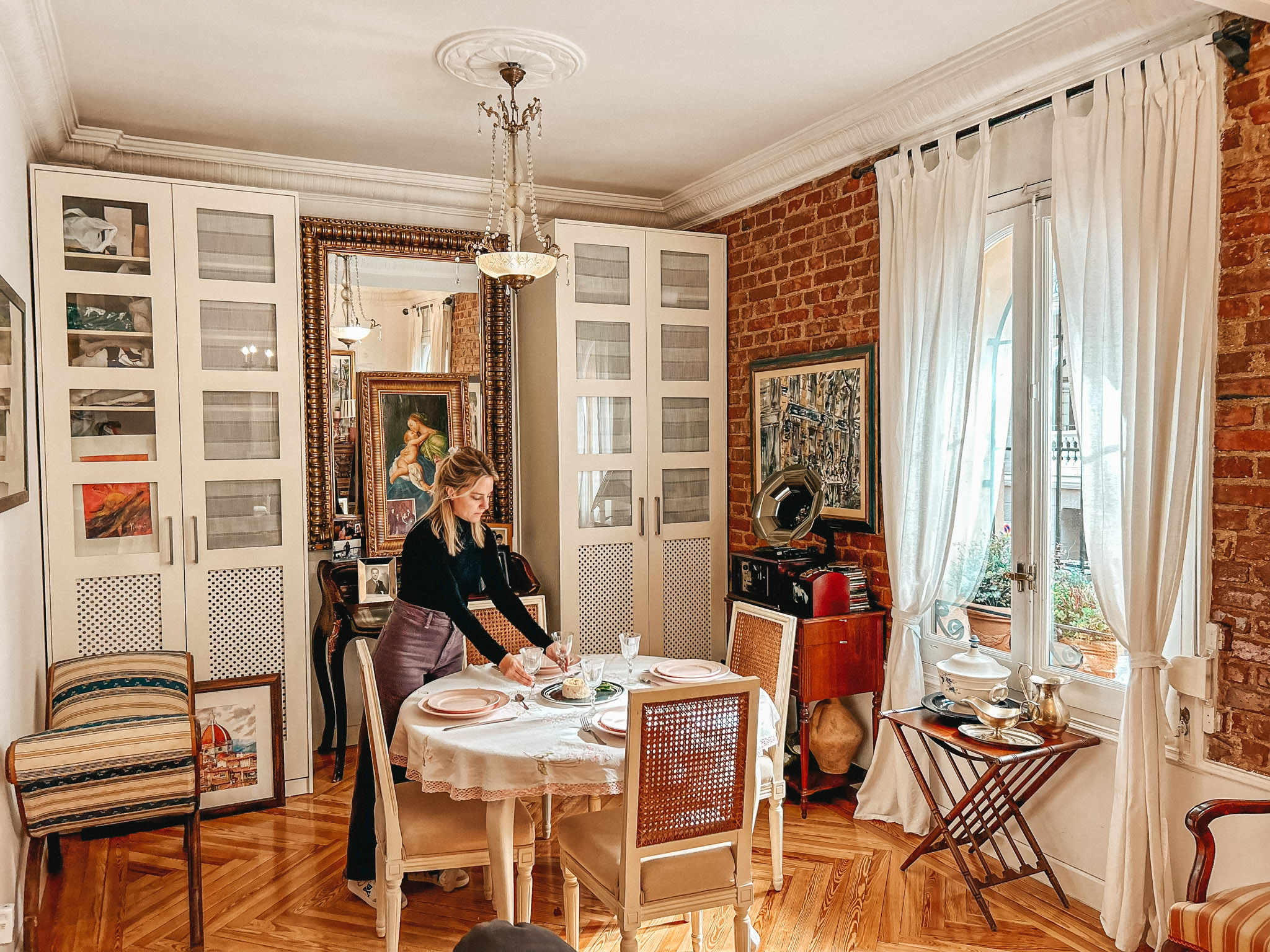 Cristina sets the table at her home in Madrid